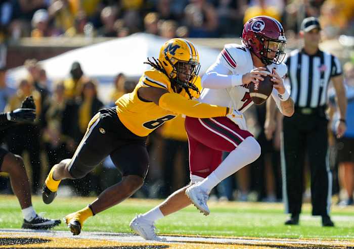 Oct 21, 2023; Columbia, Missouri, USA; South Carolina Gamecocks quarterback Spencer Rattler (7) is tackled by Missouri Tigers linebacker Ty'Ron Hopper (8) during the first half at Faurot Field at Memorial Stadium.